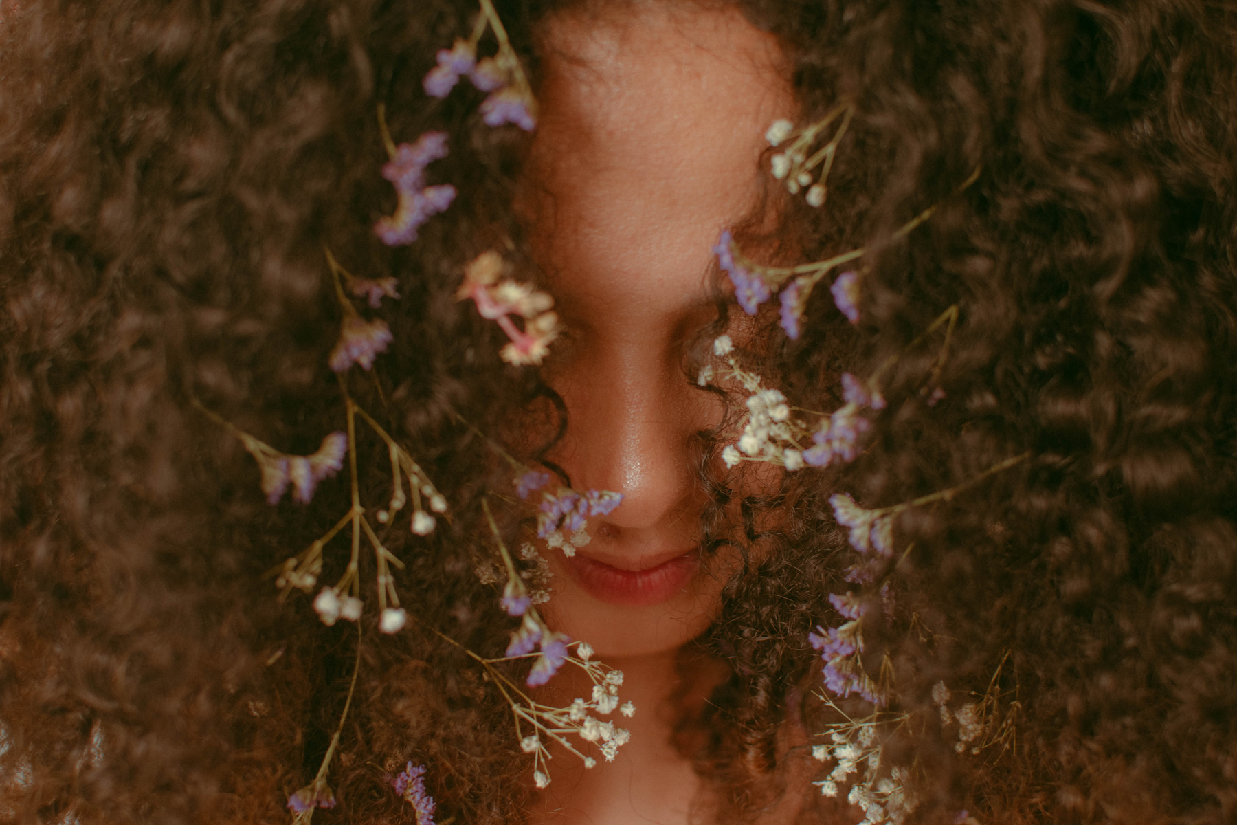 Unrecognizable woman with curly hair